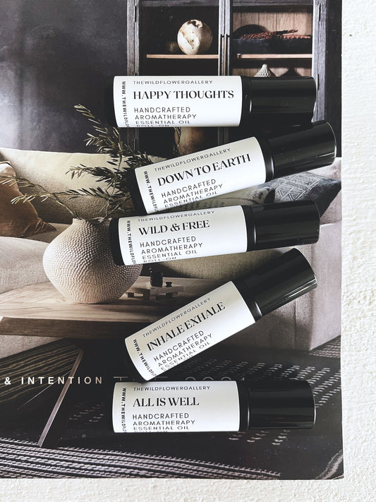 Set of handcrafted aromatherapy essential oil roll-ons in sleek black glass bottles – organic blends for wellness, mood support, and natural self-care.