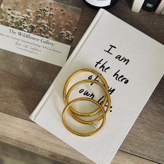 Set of handmade Buddha Bangles arranged in ceremonial setting – blessed Thai jewelry symbolizing protection, good fortune, and spiritual energy.