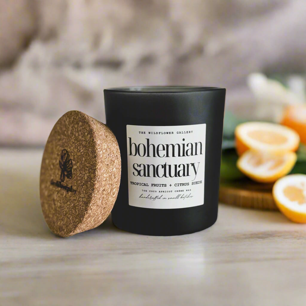 Bohemian Sanctuary candle with tropical fruits & citrus suede scent in a black matte recycled glass jar with cork lid – non-toxic, clean-burning, handcrafted coconut apricot wax candle.