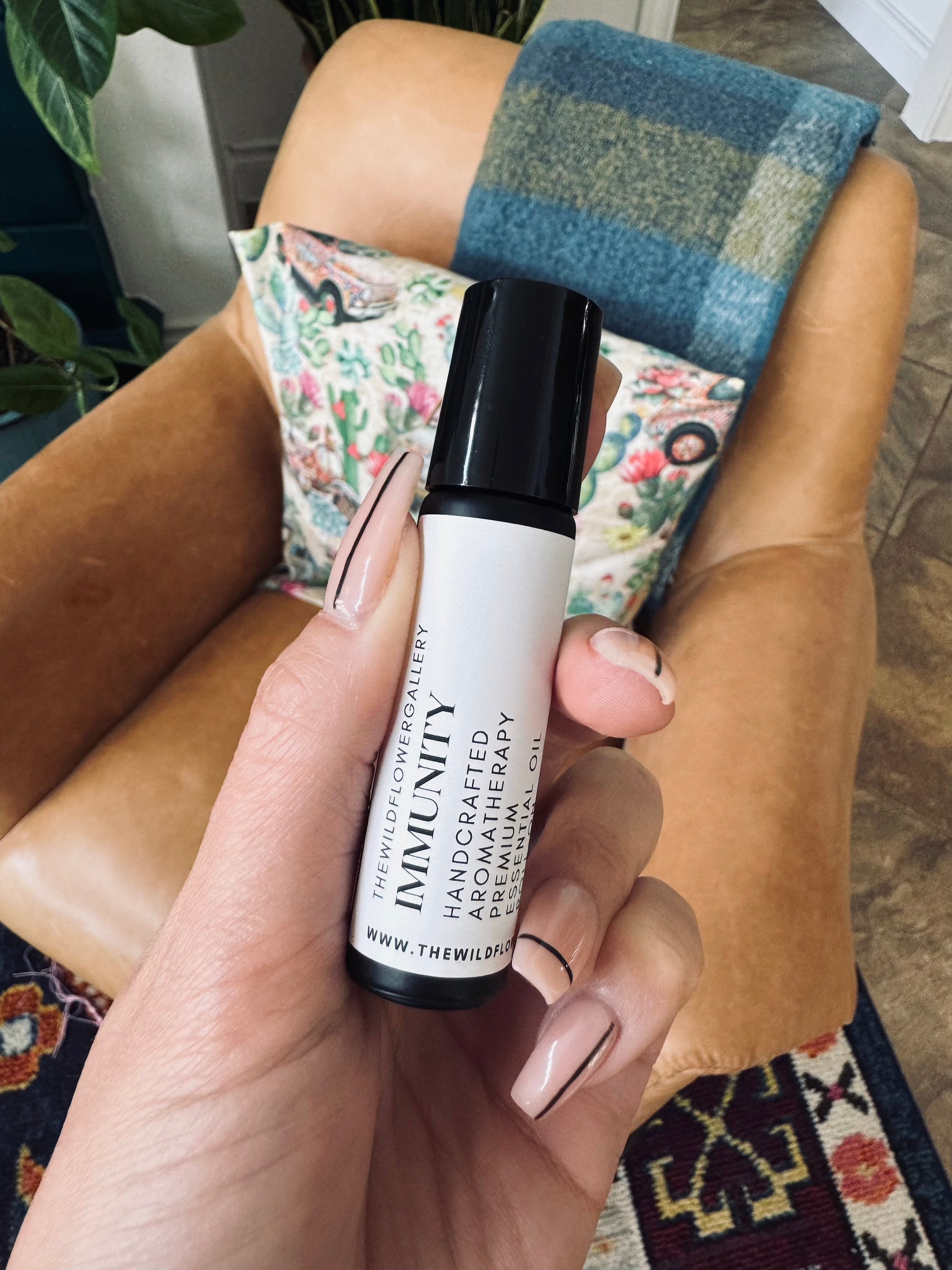 Applying essential oil roll-on to wrist – therapeutic-grade aromatherapy for relaxation, focus, and emotional well-being, perfect for daily use.