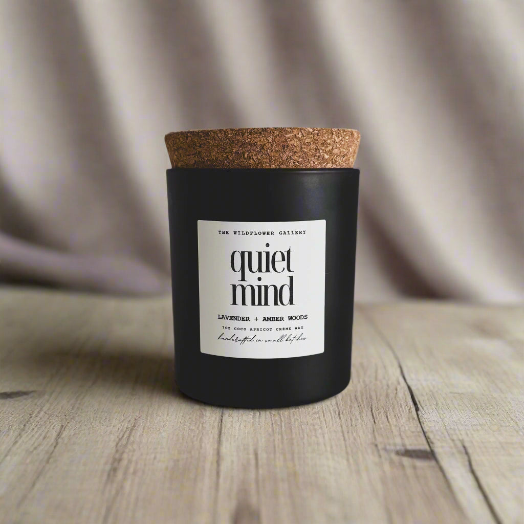 Quiet Mind candle with lavender & amber woods scent in a black matte recycled glass jar with cork lid – non-toxic, clean-burning, handcrafted coconut apricot wax candle.