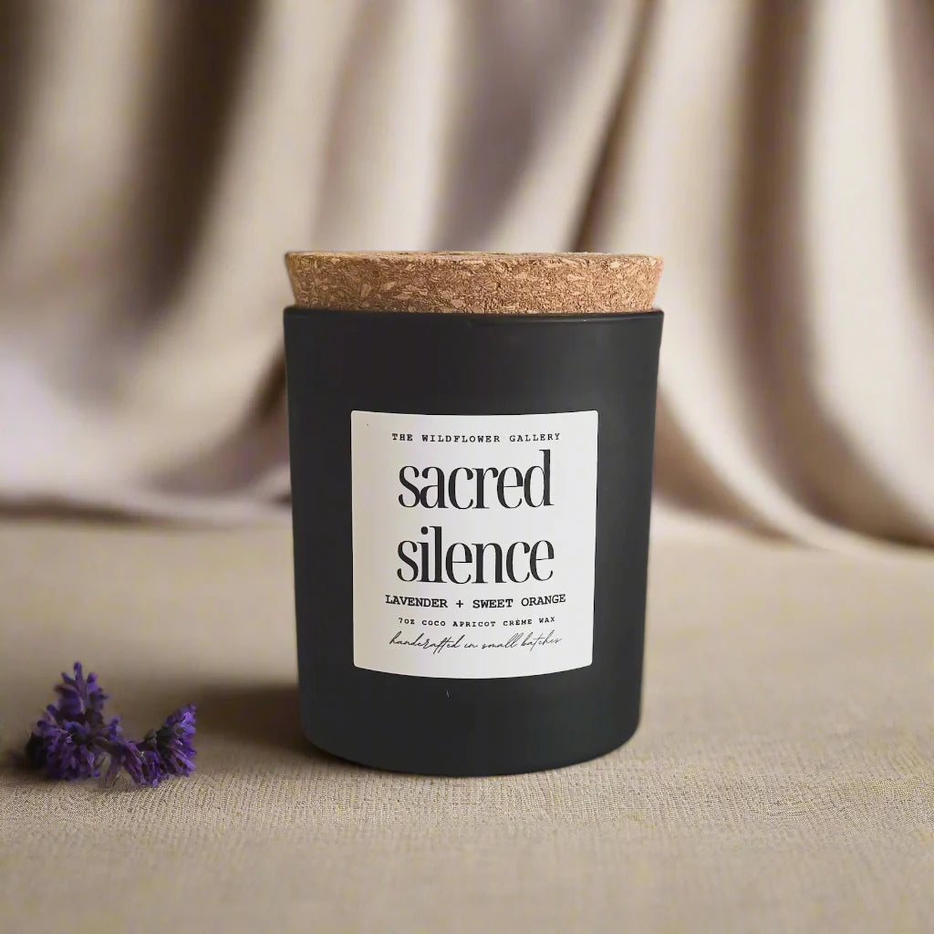 Sacred Silence candle with lavender & sweet orange scent in a black matte recycled glass jar with cork lid – non-toxic, clean-burning, handcrafted coconut apricot wax candle.