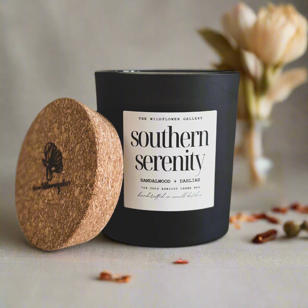 Southern Serenity candle with sandalwood & dahlia scent in a black matte recycled glass jar with cork lid – non-toxic, clean-burning, handcrafted coconut apricot wax candle.