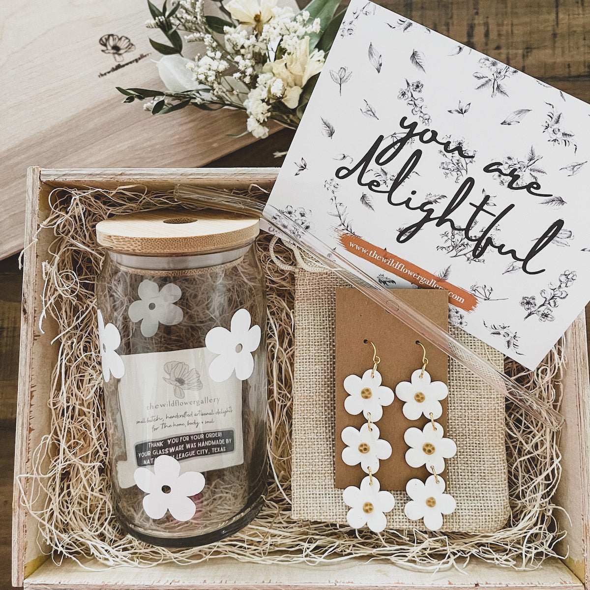 handcrafted wooden gift box with daisy glass jars and white daisy clay earrings and a glass straw. Perfect thoughtful gift for any special occasion.
