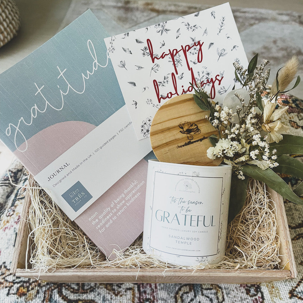 handcrafted wooden gift box with gratitude lined journal and white meditation candle, the perfect wellness gift for someone who loves to journal and meditate.