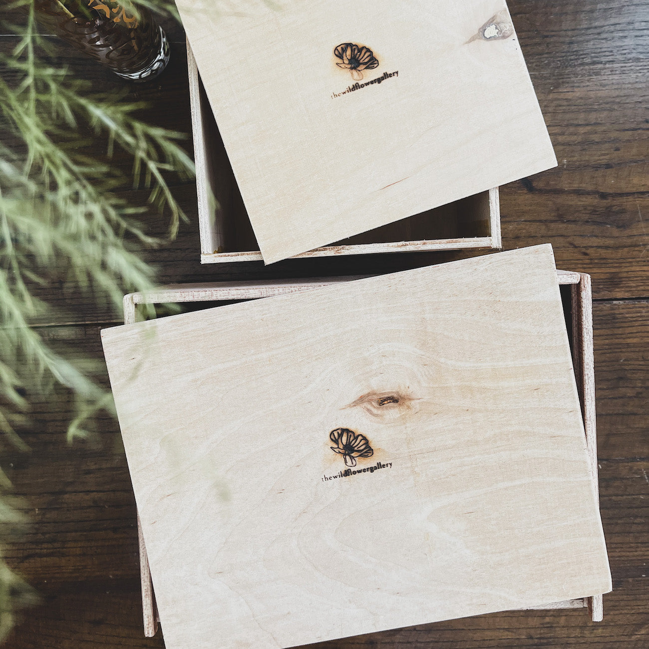 Handcrafted wooden gift box filled with wellness products, wood shavings, and dried flowers – elegant packaging for personalized self-care or special occasions.