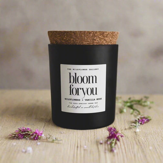Bloom For You candle with wildflowers & vanilla musk scent in a black matte recycled glass jar with cork lid – non-toxic, clean-burning, handcrafted coconut apricot wax candle.
