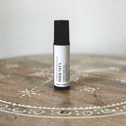 Immunity essential oil roll-on with cinnamon, clove, and lemon – wellness aromatherapy blend in eco-friendly black roller bottle.