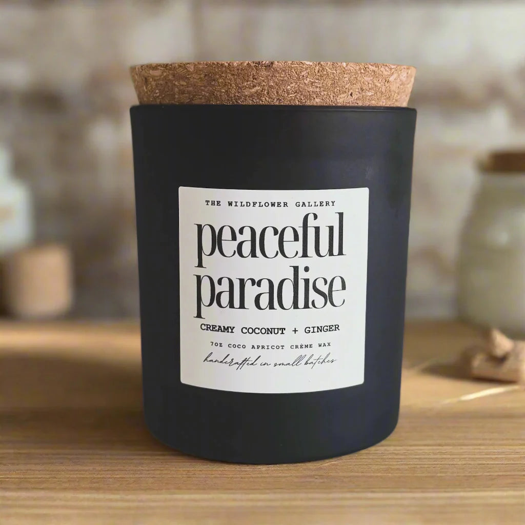 Peaceful Paradise candle with creamy coconut & ginger scent in a black matte recycled glass jar with cork lid – non-toxic, clean-burning, handcrafted coconut apricot wax candle.