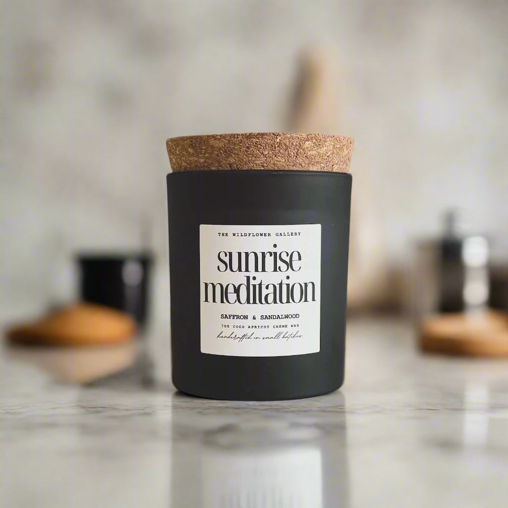 Sunrise Meditation candle with saffron & sandalwood scent in a black matte recycled glass jar with cork lid – non-toxic, clean-burning, handcrafted coconut apricot wax candle.