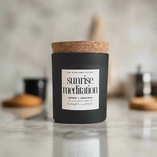 Sunrise Meditation candle with saffron & sandalwood scent in a black matte recycled glass jar with cork lid – non-toxic, clean-burning, handcrafted coconut apricot wax candle.