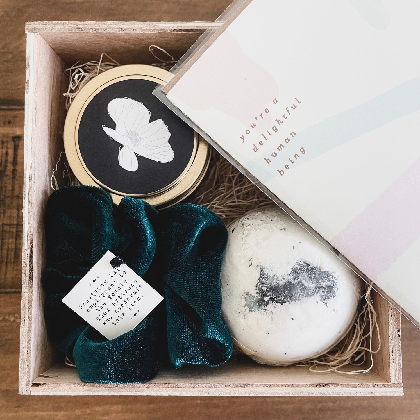 handcrafted wooden gift box with clean burning luxury candle, velvet scrunchie and all natural detoxifying bath bomb